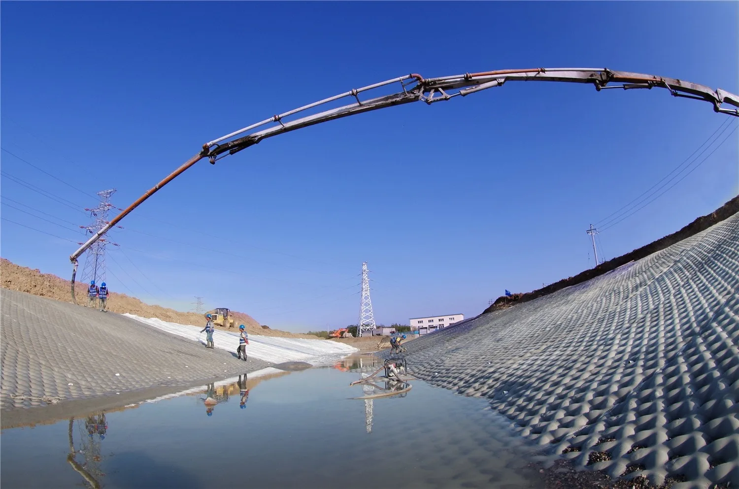 Pump boom arm over slope protection works