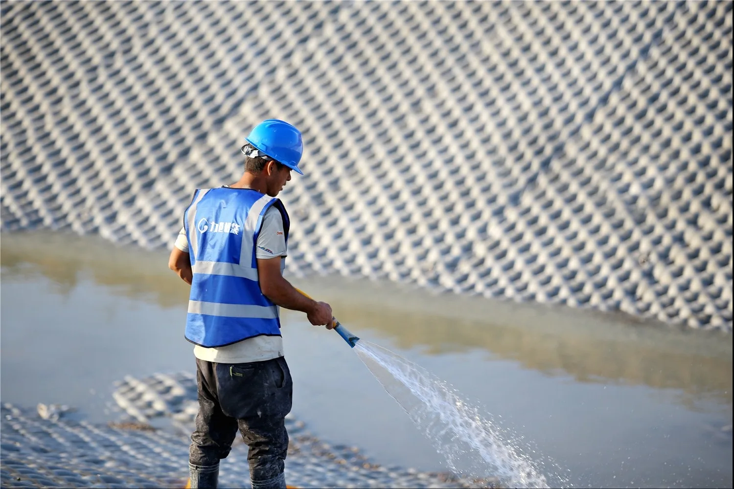 Curing water applied to newly grouted section