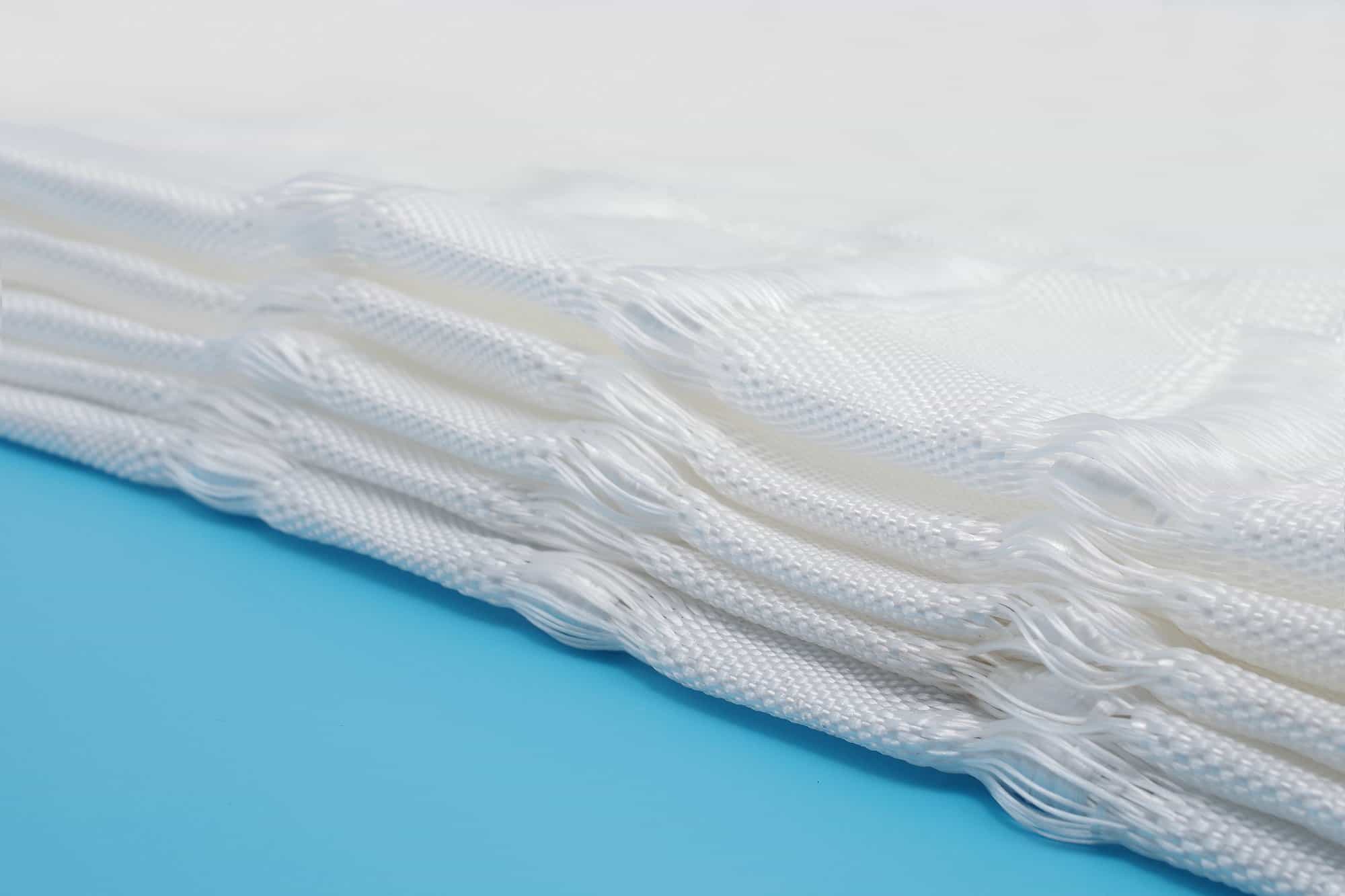Vegetated grouted mattress fabric showing open cell structure